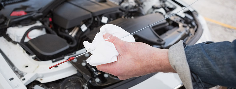 Mechanic cleaning the dipstick - Car Servicing Bathgate